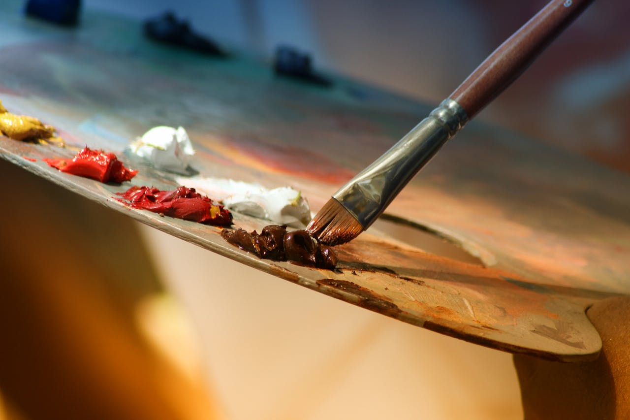 about-img Vibrant artist palette with paint and brush creating colorful artwork.