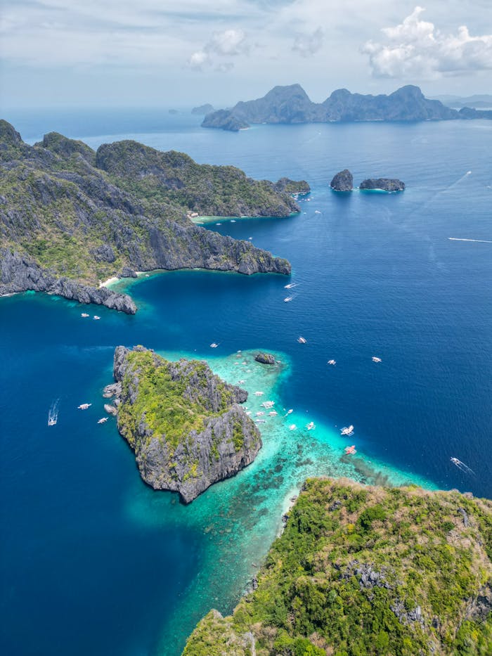 hero-img-02 A breathtaking drone shot capturing the lush islands surrounded by crystal blue waters in Palawan, Philippines.